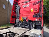 a red truck that is parked on the side of the road