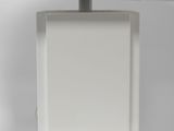 the base of a white table lamp with a white shade