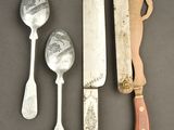 a knife, spoon, and spoon rest on a table