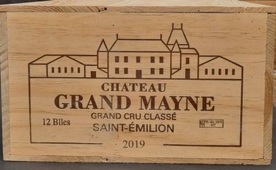 a wooden box with a label on it that says chateau grand mayone