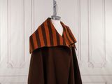 an orange and brown striped cape on a mannequin mannequin mannequin mannequin mannequin mannequin mannequin mannequin