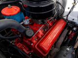 a close up of a red engine in a white car