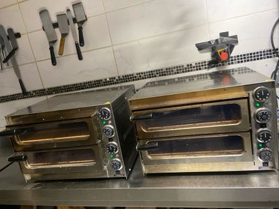 two ovens sitting on a counter in a kitchen