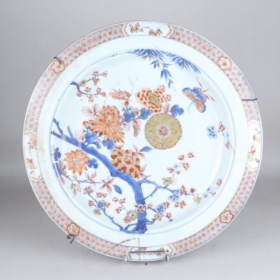 a plate with flowers and birds painted on it