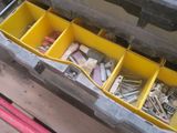a yellow box filled with assorted screws and nuts