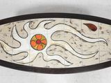 a picture of a decorative tray with a flower on it