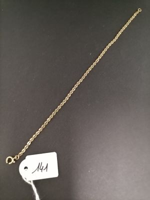 a close up of a gold necklace with a tag on it