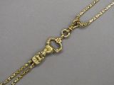 a close up of a gold chain with a clasp on it