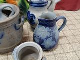 a group of blue and white vases sitting on a tiled floor