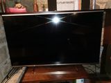 a flat screen tv sitting on top of a wooden table