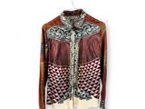 a close up of a jacket on a hanger on a white wall