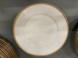 a white plate with gold trim and a gold rim