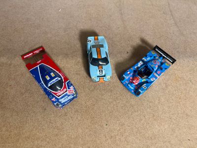 three toy cars that are sitting on the floor