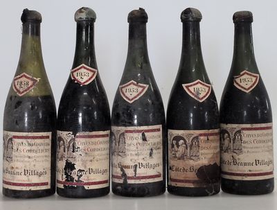 six bottles of wine are lined up on a table
