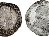 un gros plan d'une pièce d'argent sur laquelle figure l'effigie d'un homme