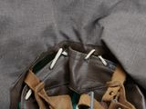 a brown leather bag with a pair of scissors in it