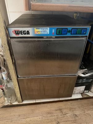 an image of a stainless steel dishwasher in the corner of a kitchen