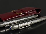 two pens sitting next to each other on a table