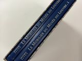 three blue pencils sitting on top of a white table