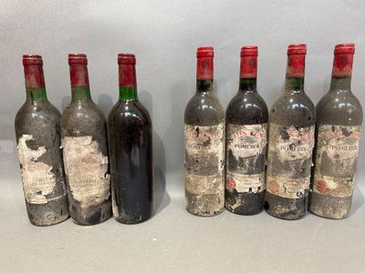 six bottles of wine are lined up in a row on a table
