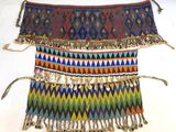 an image of a multicolored belt with metal bells and tassels