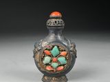 an old silver and turquoise glass snuffling bottle with a flower decoration on it