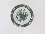 a green and white plate with a picture of a bird on it