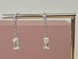silver plated earrings with clear crystal stones hanging from them