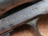 an old gun that is sitting on the floor with a tag on it