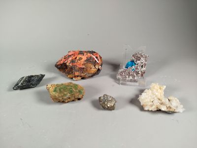 several different types of rocks and crystals on a white surface