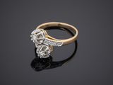 a gold and diamond ring on a black surface