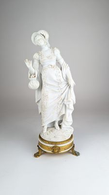 statue d'une femme tenant un enfant dans ses bras, posée sur un socle