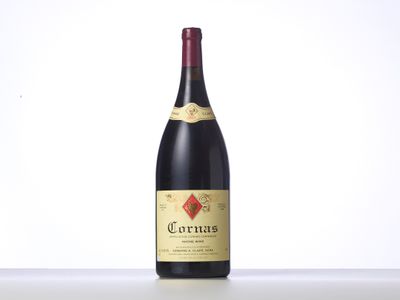 a bottle of red wine sitting on top of a table