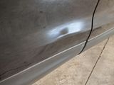 a close up of a car door handle with a hole in it