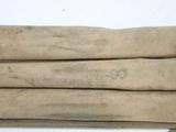 three pieces of cloth with writing on them sitting on top of a table