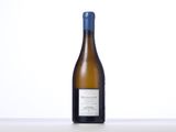 the bottle of white wine is sitting on the table