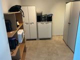 an image of a kitchen with a refrigerator, microwave, and cabinets