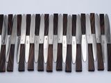 a lot of knives that are lined up on a table
