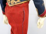 an image of a mannequin dressed in red pants and a blue jacket