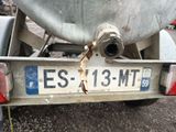 a rusted license plate on the back of a truck