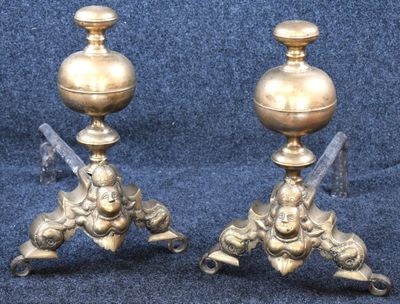 two candles that are sitting on a stand on a blue background