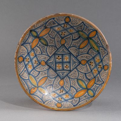 bol orné de motifs bleus, jaunes et orange sur un fond gris