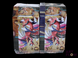 two packs of pokemon trading cards sitting on a table