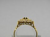 a close up of a gold ring with a black diamond in it