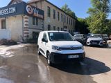 a white van that is parked in front of a building