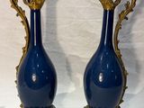two vases that are sitting on a table