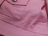 a close up of a pink jacket with a zipper on it