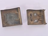two pieces of metal that are on a white surface