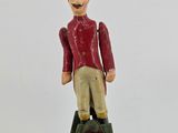 a figurine of a man sitting on top of a ladder