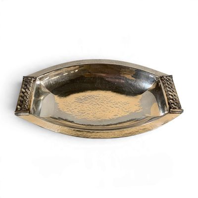 a silver plate with a decorative design on it